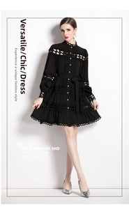 Detail view of intricate lace embroidery on the cuffs and hem of a black mini dress