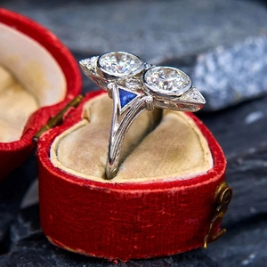 Detailed macro view of vintage Toi et Moi double diamond ring in heart velvet box