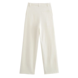 Detail view of the back pocket on cream-colored wide-leg trousers with textured fabric