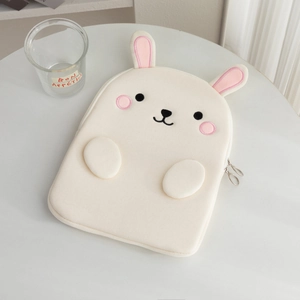 Detail of cute rabbit embroidery and 3D ears on a white laptop sleeve with metal zippers