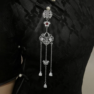 Vintage Chinese plum fan brooch with red gems and silver tassels on black cheongsam
