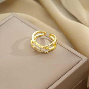 Macro detail of adjustable gold ring with sparkling baguette-cut cubic zirconia stones