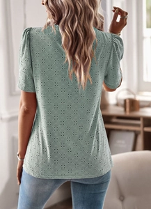 Detail view of green lace hollow-out short sleeve top with elegant puff sleeves back view