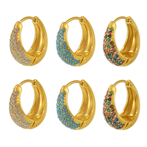 Gold-plated hoop earrings with blue turquoise and colorful zircons on a white background