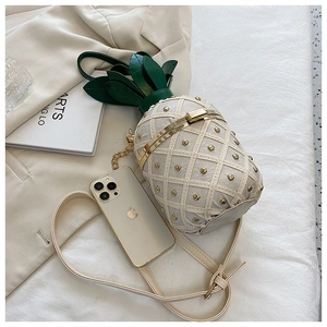 Creamy white pineapple shaped crossbody bag shown next to an iPhone for size comparison