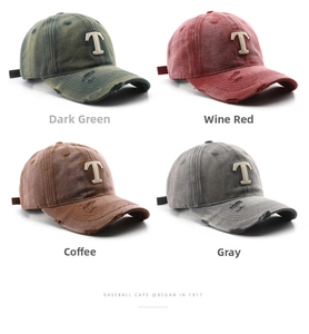 Close-up of four washed baseball caps in green, red, brown and grey with ripped brims
