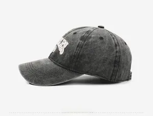 Side view of washed charcoal grey vintage baseball cap with 3D letter embroidery detail