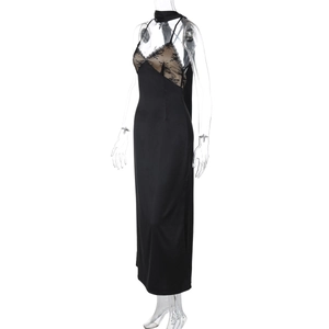 Detailed close-up of the black satin fabric with intricate beige and black lace stitching