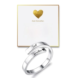 Detail of silver titanium steel bar bracelet with Just breathe engraving and gift card