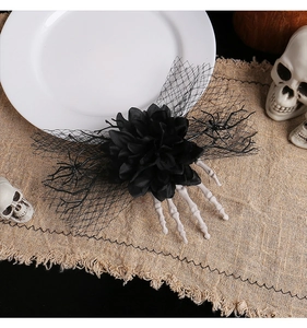 Detail of Halloween hair clip with black rose, mesh veil and white skeleton hand bone