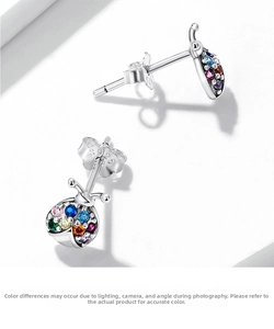 Macro detail of S925 hallmark on silver beetle earrings with colorful zircons