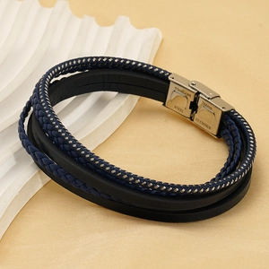 Detail of multi-layer blue braided cord and black leather bracelet with steel buckle