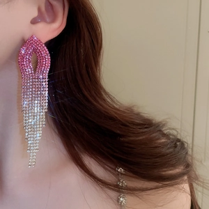 Close-up of long tassel earrings with pink gradient rhinestones on model side profile