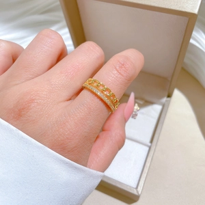 Close-up of gold chain ring featuring micro-pave crystals in double-layer design