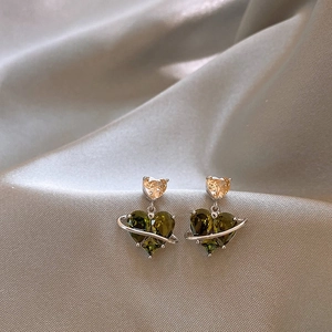 Detail of silver drop earrings with olive green heart zircon and champagne heart accents