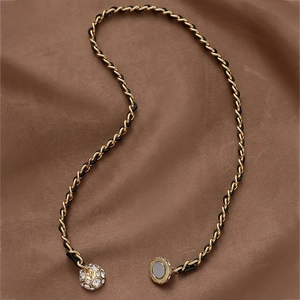 Detail of black leather woven chain necklace with crystal sphere and magnetic clasp