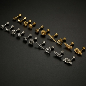 Macro view of stainless steel ball back earrings with skull and gothic design elements