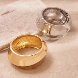 Minimalist wide metal twisted bangle in gold and silver finish with hinge closure