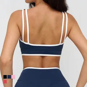Dark blue yoga sports bra with cross back straps and white contrast trim detailing
