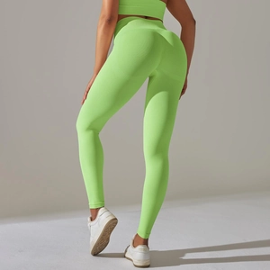Detail of high-waisted neon green seamless knitted yoga leggings with ribbed texture