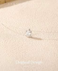 Detailed close-up of a single VVS1 moissanite pendant on an invisible fishline necklace