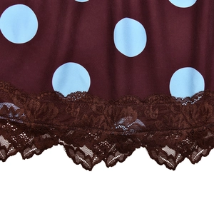Detailed macro view of dark brown polka dot fabric with blue patterns and lace trim