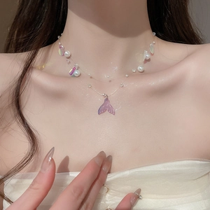 Macro shot of double-layer mermaid tail pearl necklace on collarbone for women