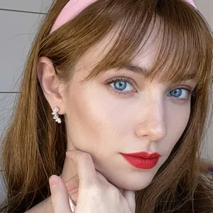 Close-up of elegant silver crescent moon earrings with cubic zirconia on a model's ear
