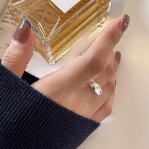 Minimalist 925 sterling silver irregular ring with polished surface on a vintage book
