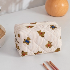 Detailed view of quilted cotton cosmetic bag featuring cute bear pattern and top zipper closure
