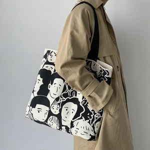 Detail of canvas tote bag featuring a minimalist black and white hand-drawn portrait art