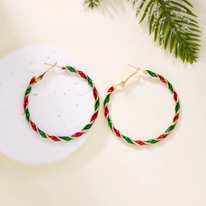 Detailed close-up of Christmas hoop earrings with red, green, and gold spiral twist design