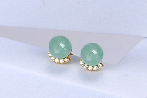 Macro detail of S925 silver earrings with green aventurine stone and crystals