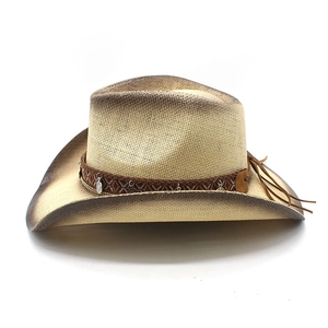 Detail of western straw hat featuring ethnic woven band and metallic pendant charms