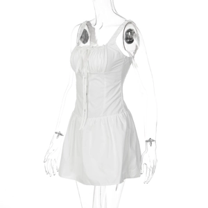 Close-up of white slim fit mini dress featuring button front and drawstring chest detail
