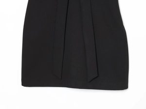 Détail de la robe noire courte avec rubans verticaux élégants et tissu lisse soigné