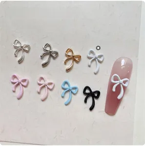 Macro shot of 6x9mm colorful alloy bow nail charms showing varied metal and solid finishes