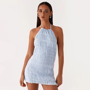 Detail of light blue backless halter dress with ruched fabric texture and tied straps