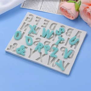 Alphabet silicone mold with translucent mint blue DIY resin letters on a blue background