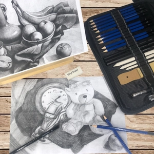 Detail view of sketching set featuring graphite pencils, charcoal, and vinyl eraser