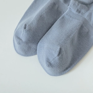Close-up of fine knit stitching and smooth toe seam on breathable cotton ankle socks