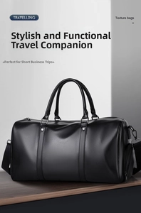 Close-up of black lychee grain leather duffle bag with side compartment and silver hardware