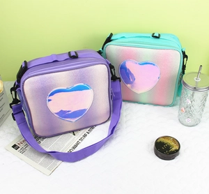 Close-up of glitter lunch bags with heart laser patches and adjustable shoulder straps
