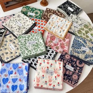 Collection of floral cotton linen square neck scarves in various patterns on a white table