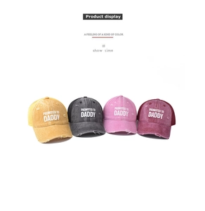 Detail of distressed baseball caps with 'Promoted to Daddy' print and breathable mesh