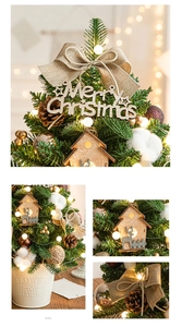 Mini Christmas tree detail with LED lights, pine cones, and a decorative wooden house