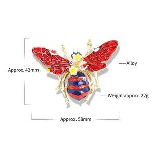 Vintage gold bee brooch with red polka dot wings and colorful floral enamel details