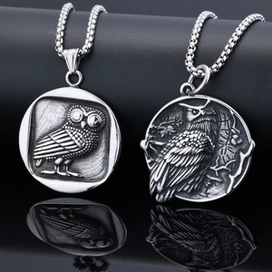 Macro shot of owl embossed pendant in silver finish with thick circular link chain