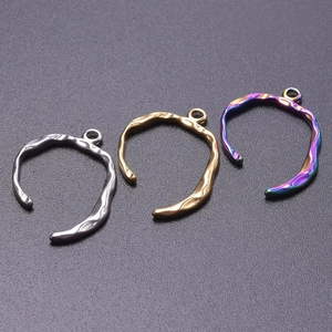 Macro detail of irregular lava texture U-shaped pendants in gold, silver and rainbow