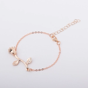 Detailed view of a rose gold floral bracelet featuring a delicate rose flower and leaf motifs